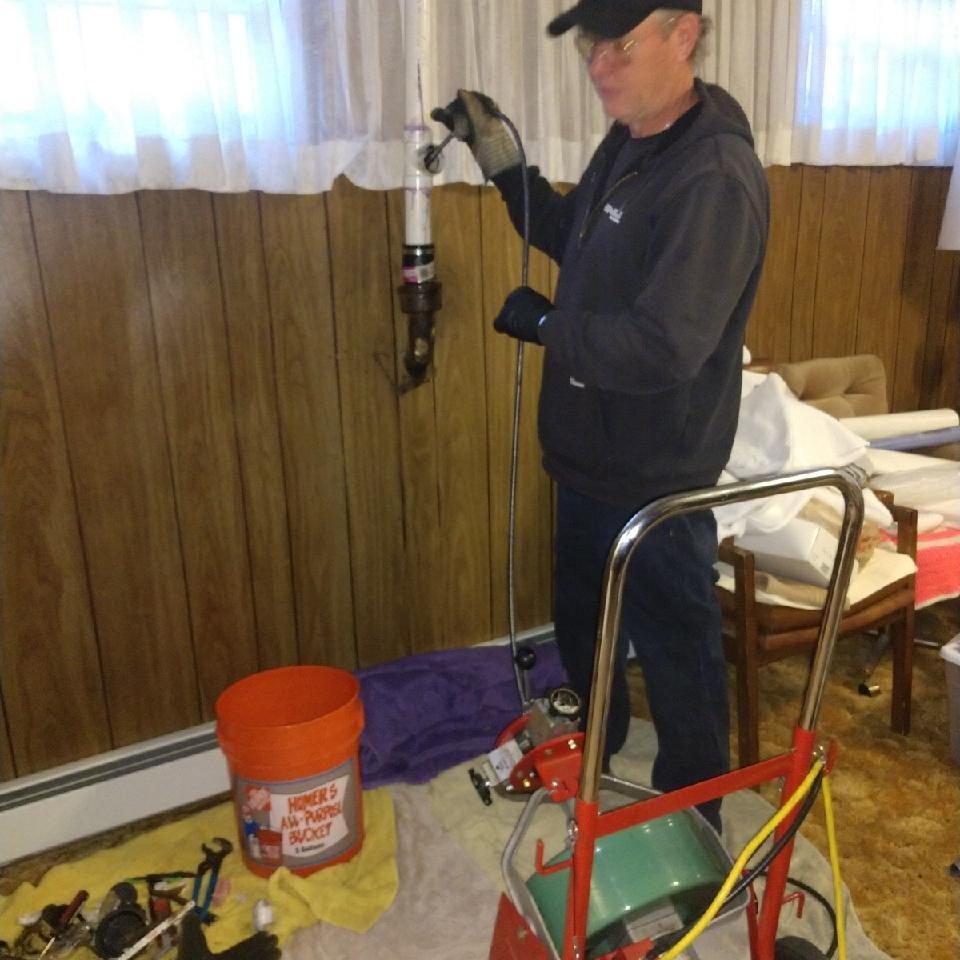 A man working on the Drain Cleaning